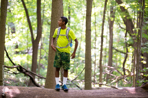 Teenager on Top of Fallen Tree in Forest Preserve