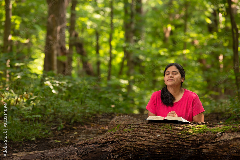 Hispanic Woman Meditating on Her Bible Reading in Forest Preserve Hispanic Woman Meditating on Her Bible Reading in Forest Preserve