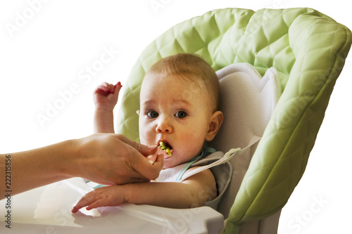 Mom feeding baby in highchair