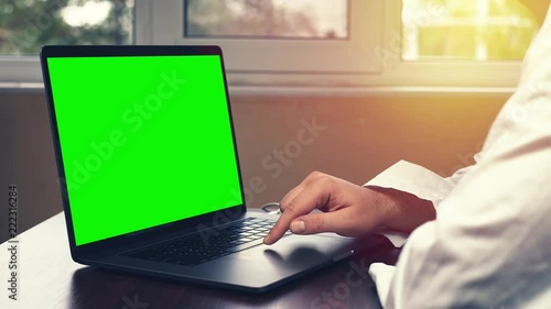 Doctor using laptop in the office. Young medical professional using touchpad on her laptop computer.