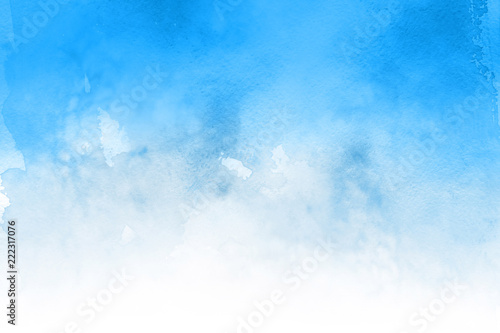 Blue winter watercolor ombre leaks and splashes texture on white watercolor paper background. Painted ice, frost and water.