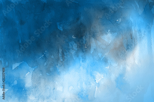 Blue winter watercolor ombre leaks and splashes texture on white watercolor paper background. Painted ice, frost and water.