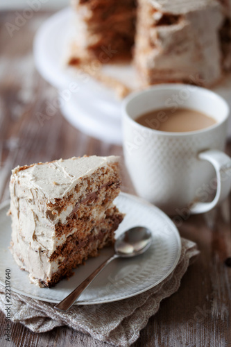 ePiece of crispy coffee and nut meringue cake with butter cream frosting