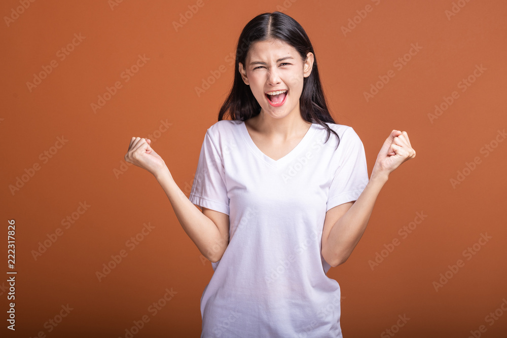 Winning woman isolated over orange background. Winning woman isolated over orange background.