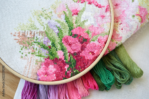 Foto Hoop with aida with a fragment of an embroidery