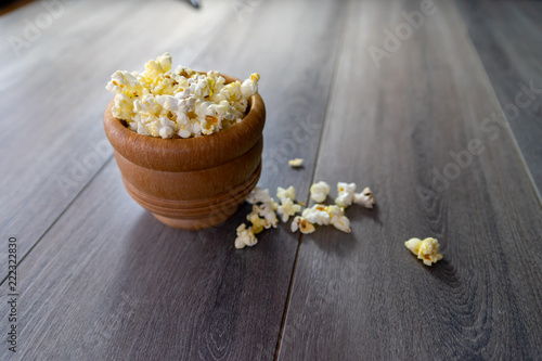 Popcorn in a mortar with pestle on wood table 