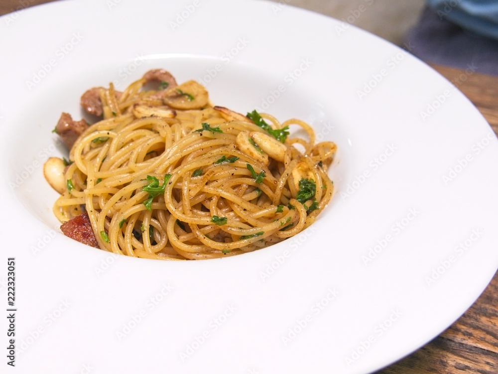 Italian cuisine, Spicy spaghetti with pork sausage and garlic in white bowl