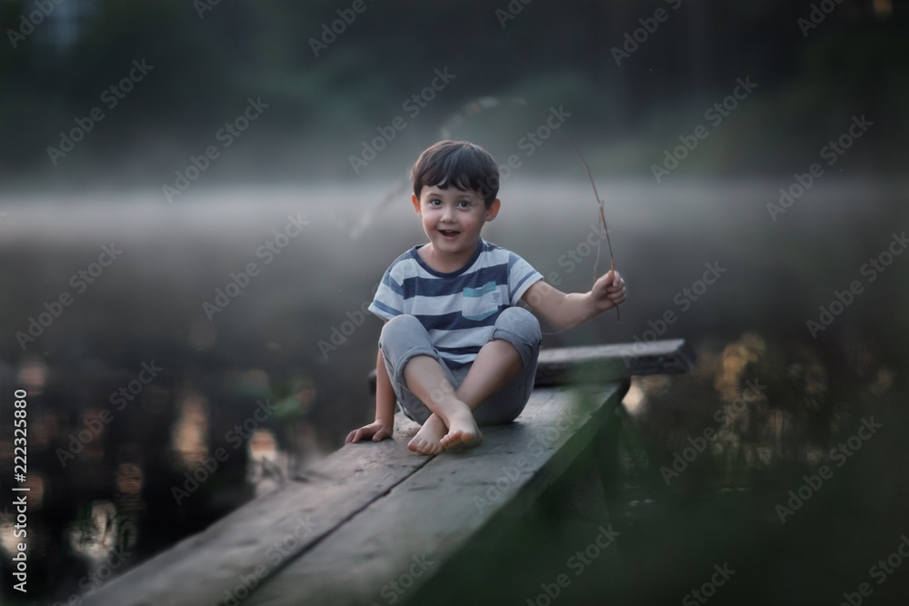 oy sitting on the wooden jetty