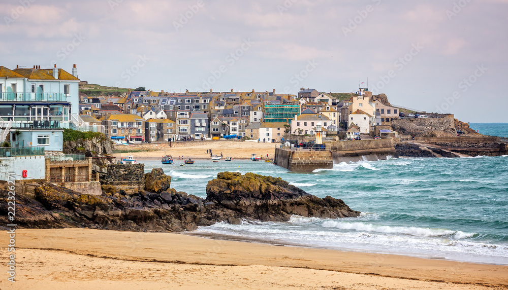 Harbour at St Ives with waves crashing against the harbour wall taken in St Ives, Cornwall, UK on 28 February 2016