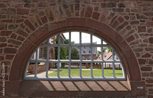 Monastery wall with iron lattice window, Seligenstadt, Hesse, Germany