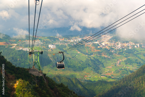 Cable car In the middle of the valley, fog in cloud background of country in Fansipan mountain SAPA VIETNAM. photo