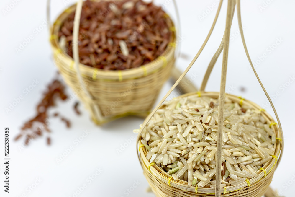 Thai rice story concept by brown rice and jasmine raw rice in embroidery basket Thai rice story concept by brown rice and jasmine raw rice in embroidery basket