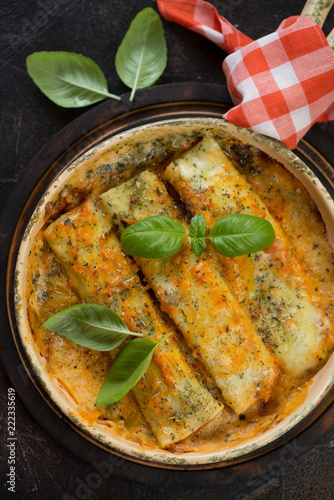 Above view of baked cannelloni with spinach and cheese filling, vertical shot