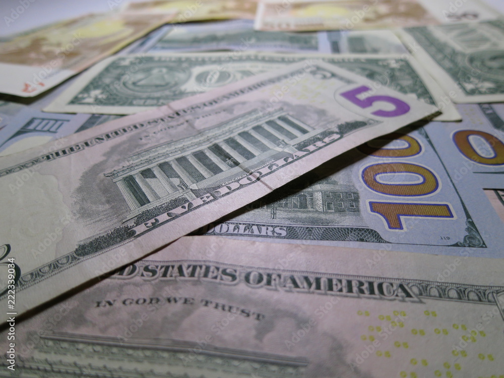 US dollars laid out on the table. US dollars laid out on the table.