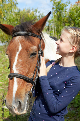Portrait of young horsewoman and brown horse. Girl with horse.