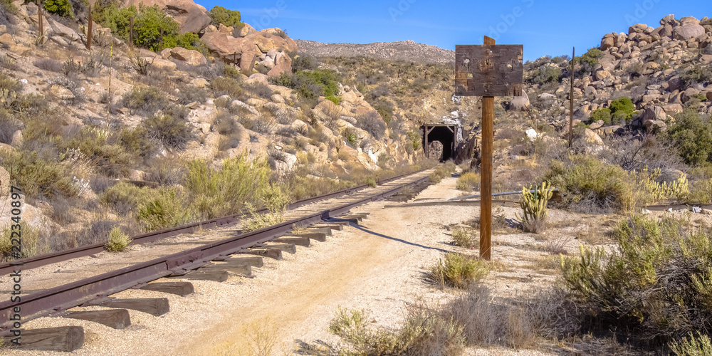 Railroad leads to a tunnel on California desert