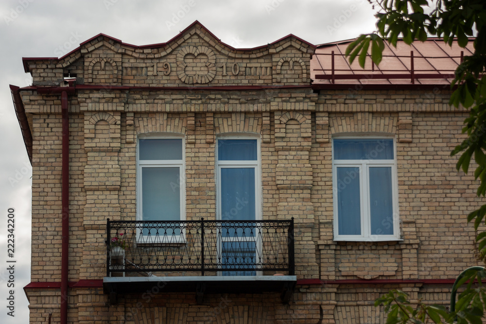 Grodno. Belarus. The pediment of the old brick house with brick-lined decorations and the date of construction of the house of 1910.