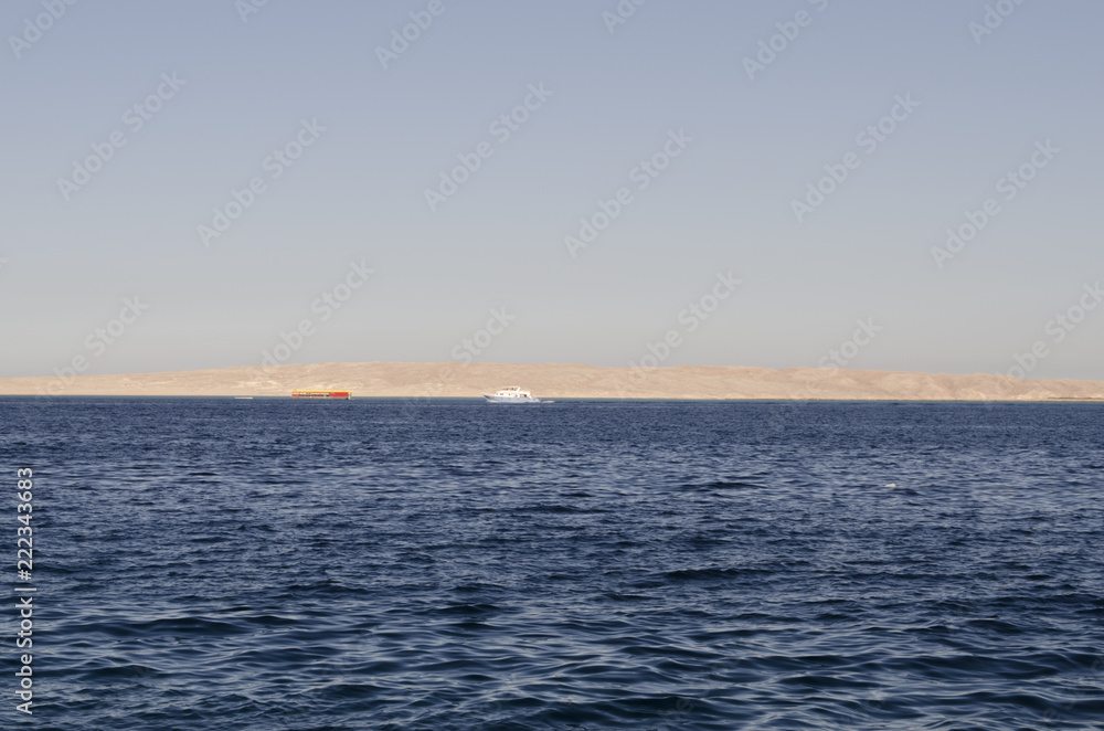 Fototapeta premium Sea and yachts with a shore in the distance