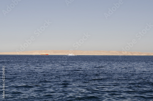 Sea and yachts with a shore in the distance © Вячеслав Лелюга