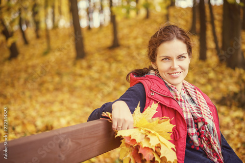 Young beautiful woman in autumn park