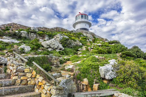Old lighthouse (1857) sits on top of cliffs of Cape Point in Cape of Good Hope Nature Reserve on southern tip of Cape Peninsula in South Africa. The Atlantic and Indian oceans converge at Cape Point.