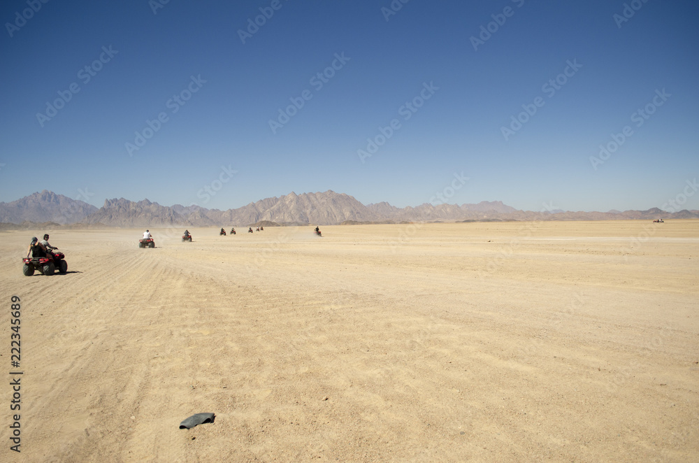 a group of people on quad bikes in the desert a group of people on quad bikes in the desert