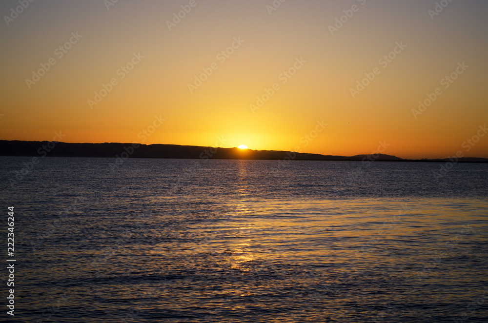 a yellow sunset over the sea
