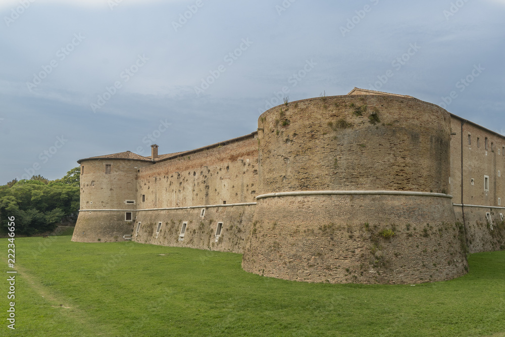 the rocca, or castle, immersed in the green of the military architecture of the fifteenth century. square, with four great cylindrical towers, the various slits and ports for cannon