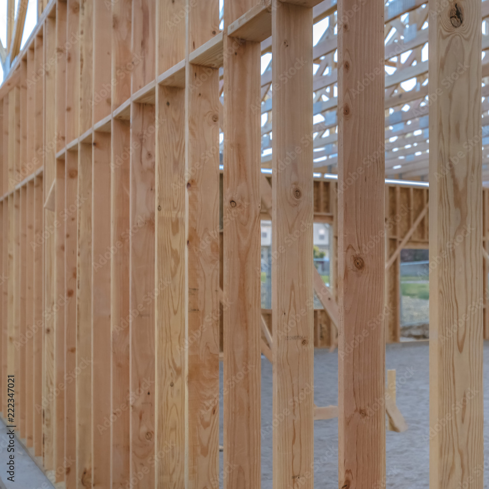 Some vertical wooden beams sandy ground square Some vertical wooden beams sandy ground square