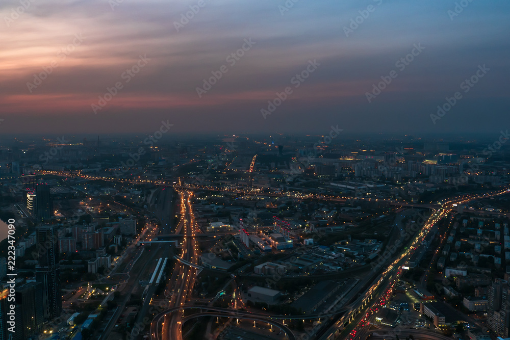 Aerial view panorama of night city Moscow, Russia. Urban cityscape after sunset with illuminated streets and building