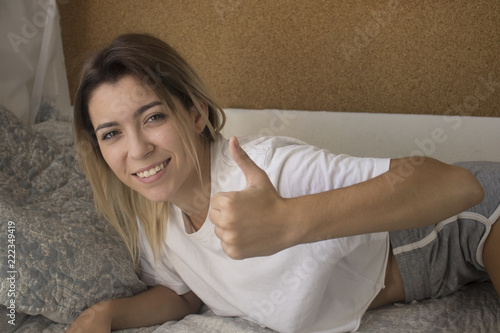 Happy woman in bed at home photo