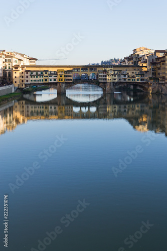 Famous bridge Ponte Vecchio over Arno river at sunset in Florence, Tuscany, Italy