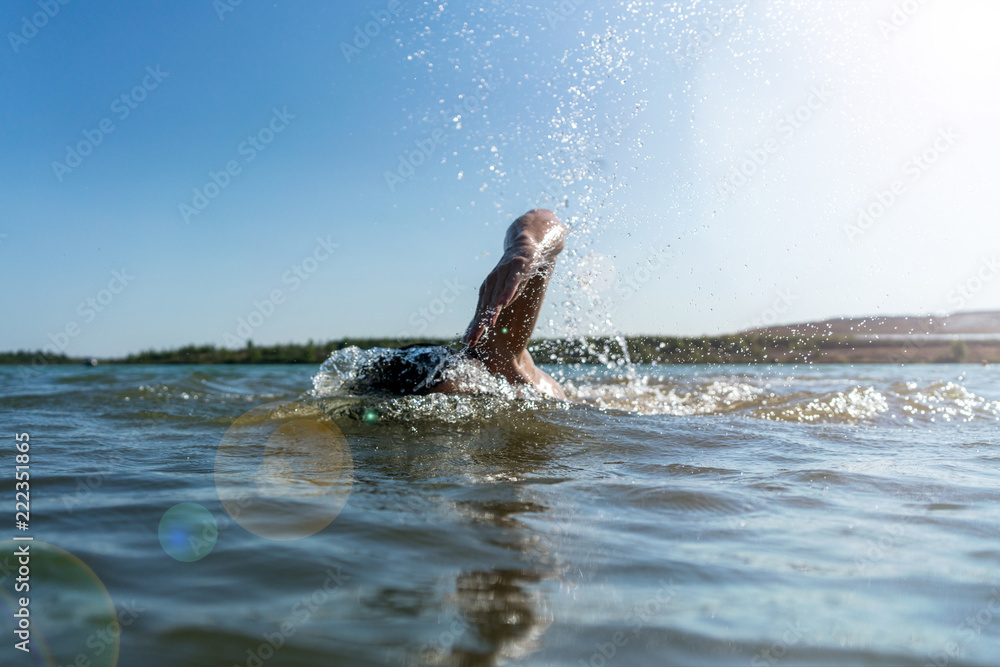 Obraz premium Man swimming in a lake background