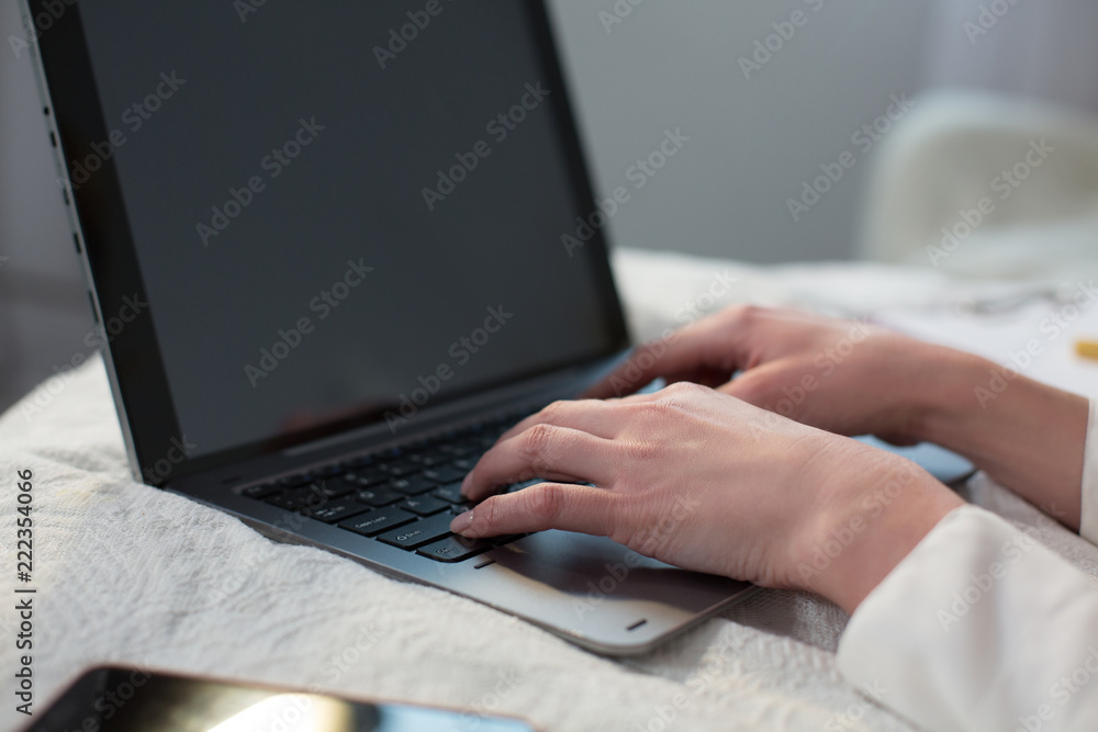 Woman hands typing message on laptop while lying in bed. Business in bed concept. Woman hands typing message on laptop while lying in bed. Business in bed concept.