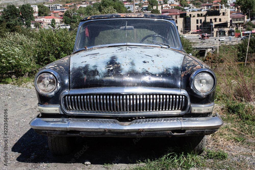Old car on the background of the old town. Rarity. Vintage Old car on the background of the old town. Rarity. Vintage