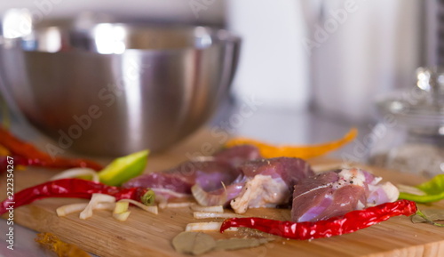 Food. pieces lamb, peppers and onions, wooden board