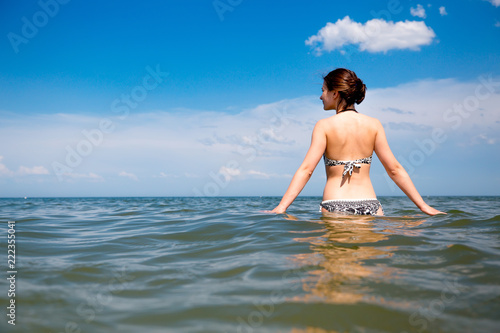 Girl in the sea on blue sky