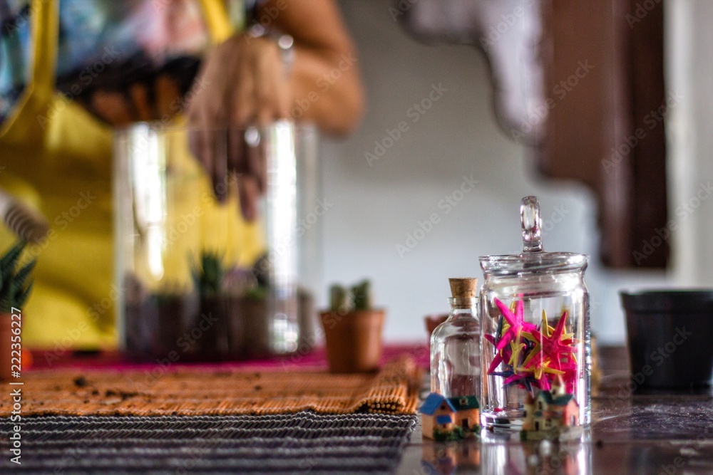 Woman planting terrarium for Christmas Woman planting terrarium for Christmas