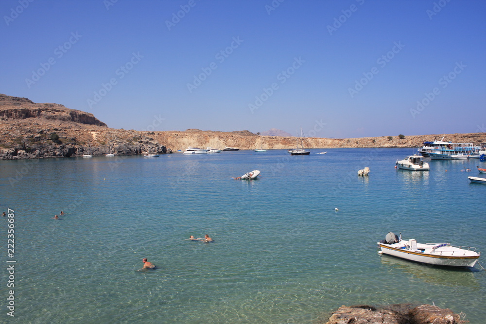 view of the coast with boats in Lindos bay, Greece