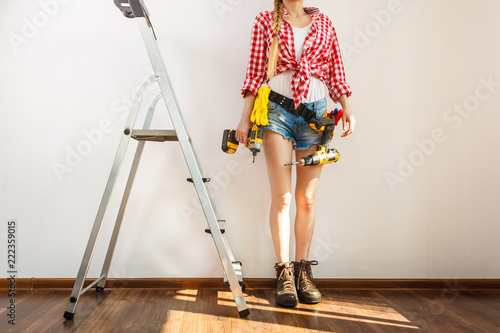 Woman with repairing tools and ladder