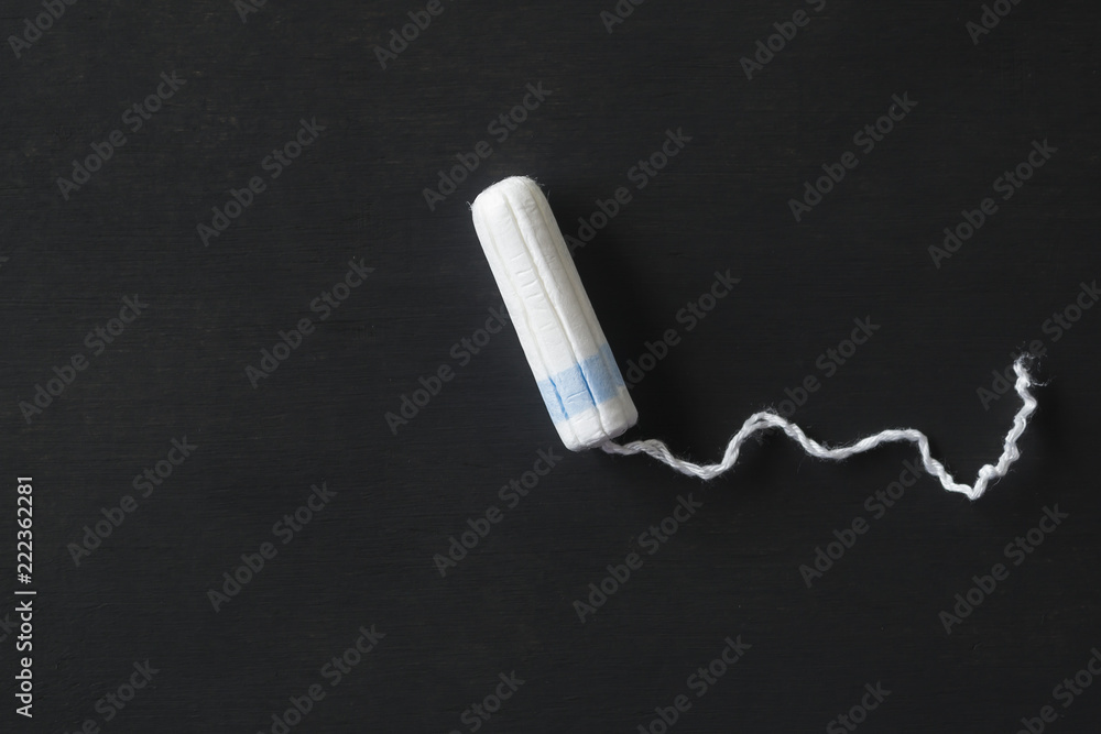 Hygienic tampon on a black background. Hygienic tampon on a black background.