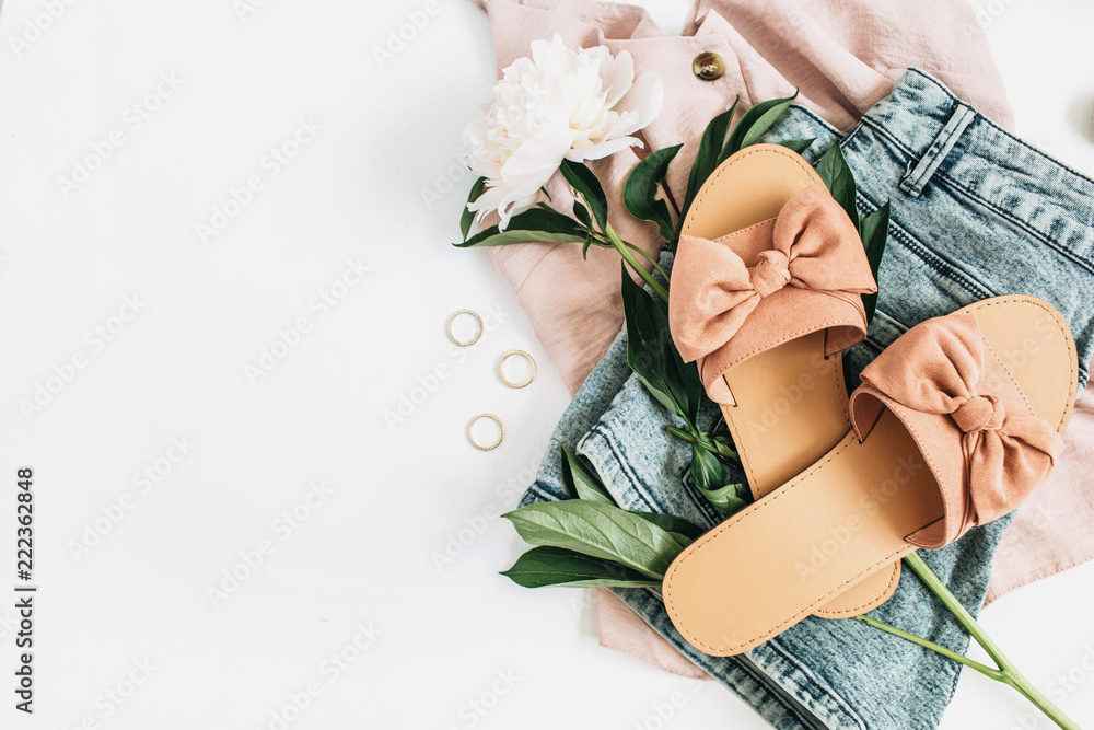 Woman fashion background with white peony flower, slippers, sunglasses, earrings, shorts, t-shirt. Flat lay, top view beauty or fashion blog lifestyle concept.