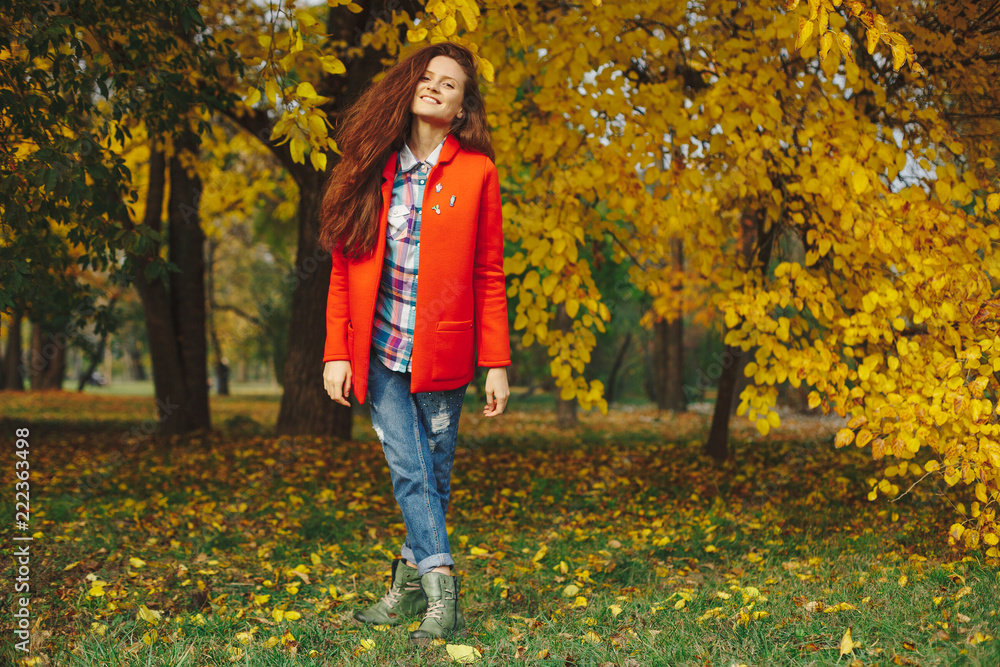 Girl with long wavy hair enjoying autumn in the park. Girl with long wavy hair enjoying autumn in the park.