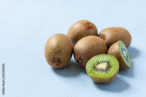 Fresh kiwi fruits on a pale blue background