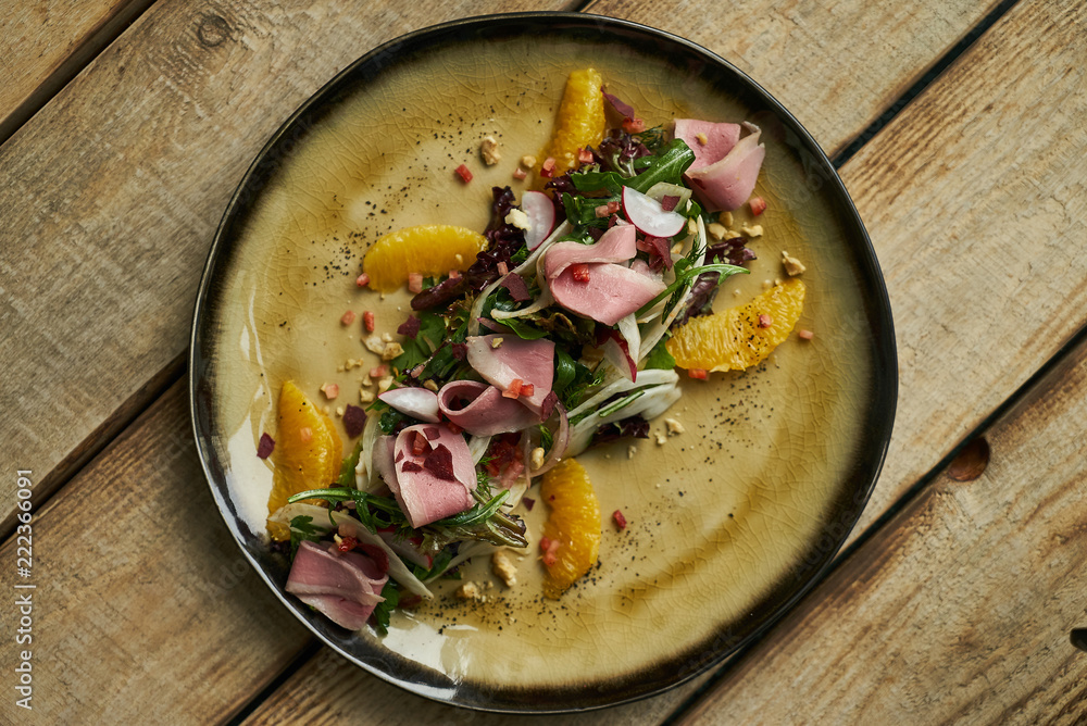 Fresh vegetable salad with Smoked duck breast. Healthy diet salad with smoked duck, Candied Walnuts, Spring Greens, Orange and Herbs Fresh vegetable salad with Smoked duck breast. Healthy diet salad with smoked duck, Candied Walnuts, Spring Greens, Orange and Herbs