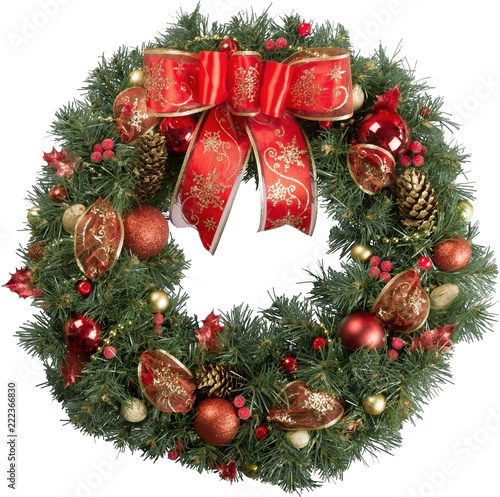Christmas wreath made of fir tree and cones with red bow and