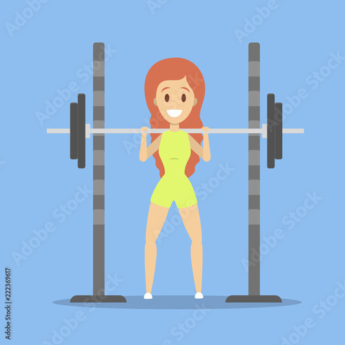 Pretty woman lifting heavy barbell in the gym