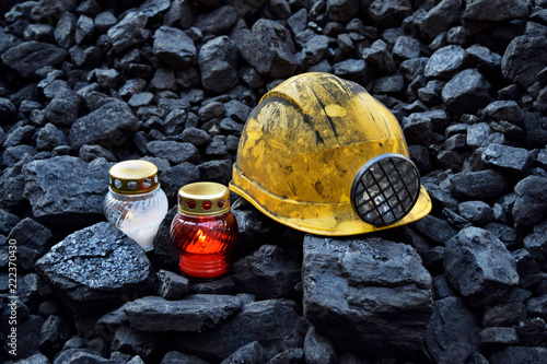 Vigil light, candle with mining helmet on cheap of coal