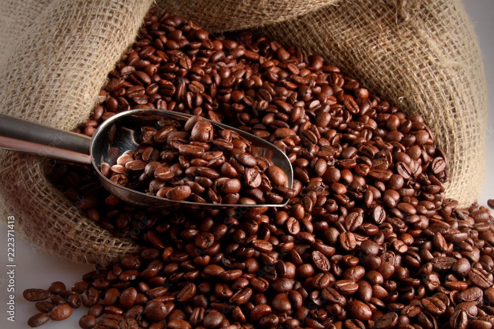 Coffee Beans With Scoop Falling Out Of Sack Close-up Coffee Beans With Scoop Falling Out Of Sack Close-up