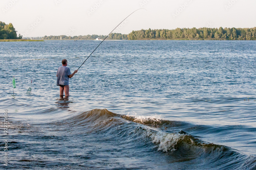 Shot of water spatter from fisherman while throwing fishing net on the lake. Fisherman with fishing net in the morning light sunshine. Stop motion of water drop. Shot of water spatter from fisherman while throwing fishing net on the lake. Fisherman with fishing net in the morning light sunshine. Stop motion of water drop.